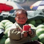 Chinese boy eating watermellon