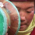 Young Monk Chanting With Drum